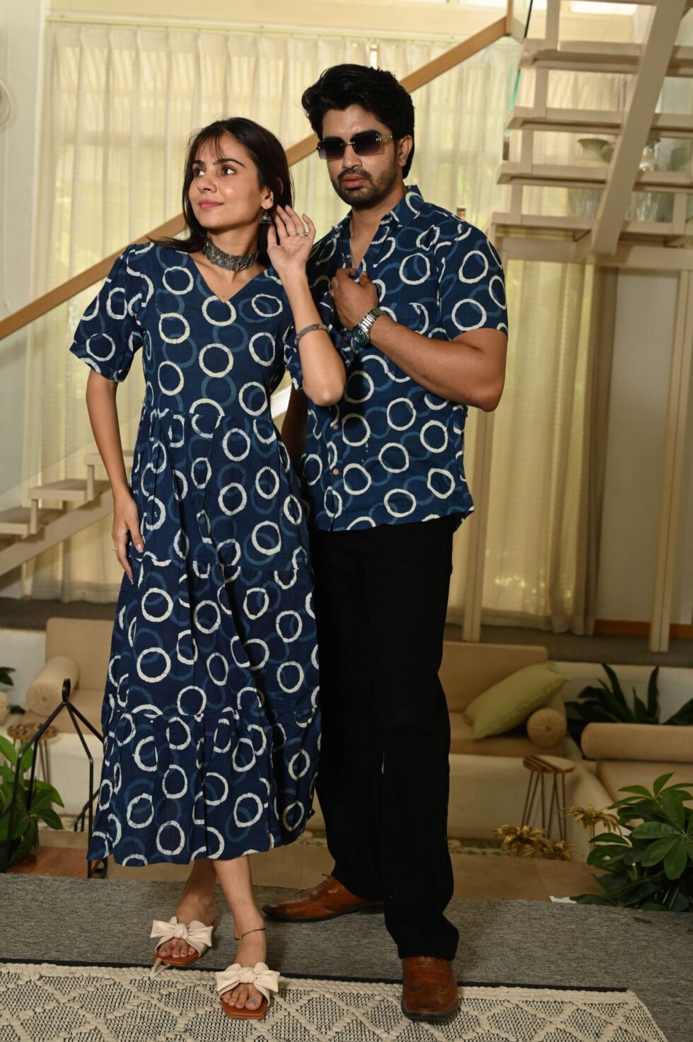Front view of woman in navy blue Anarkali midi dress and man in coordinated printed shirt