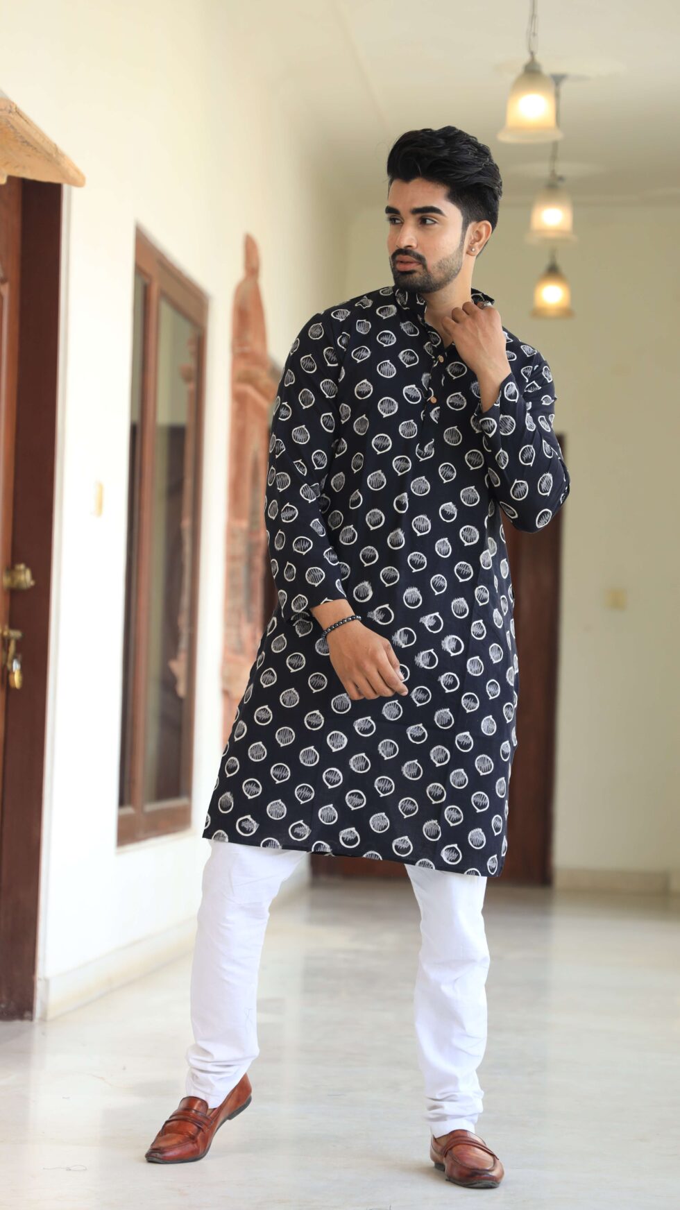 Close-up of intricate white prints on black kurta