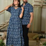 Couple wearing matching blue Ikat print ethnic outfits for festive occasion