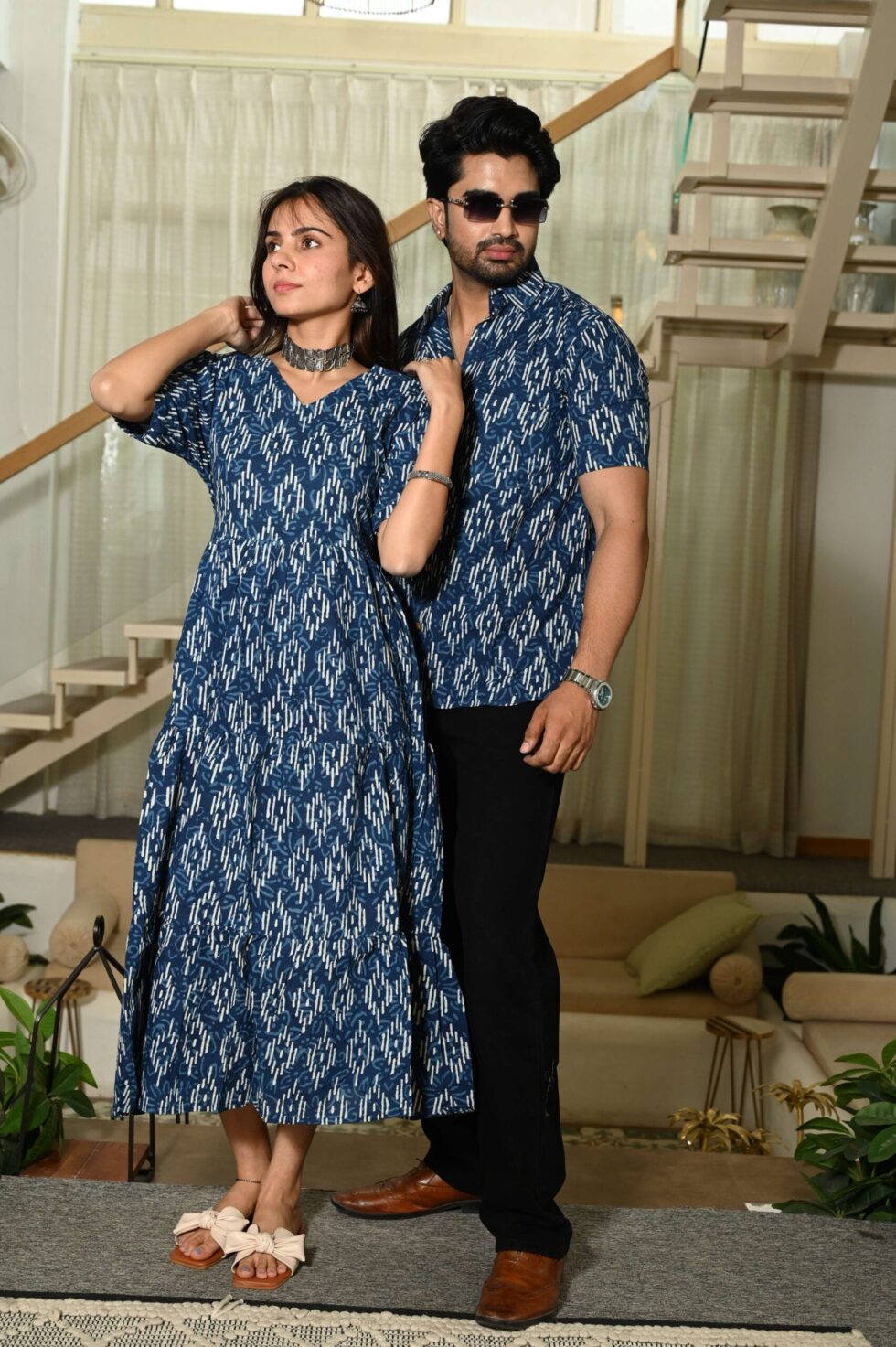 Couple wearing matching blue Ikat print ethnic outfits for festive occasion