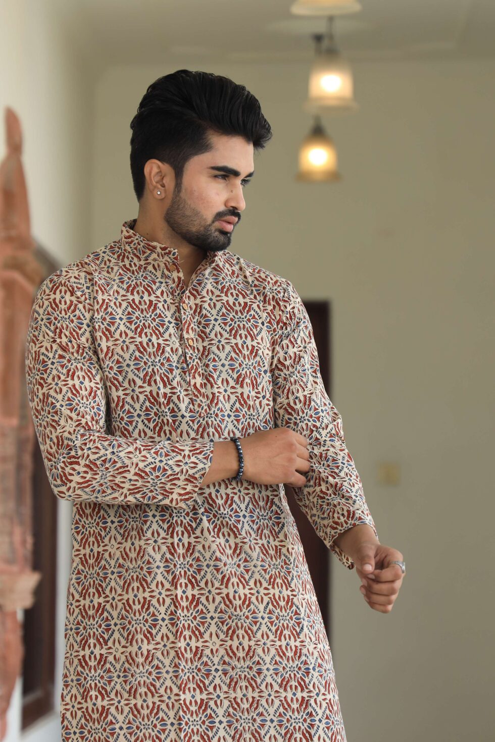 Model wearing the complete kurta set, posing in a traditional setting