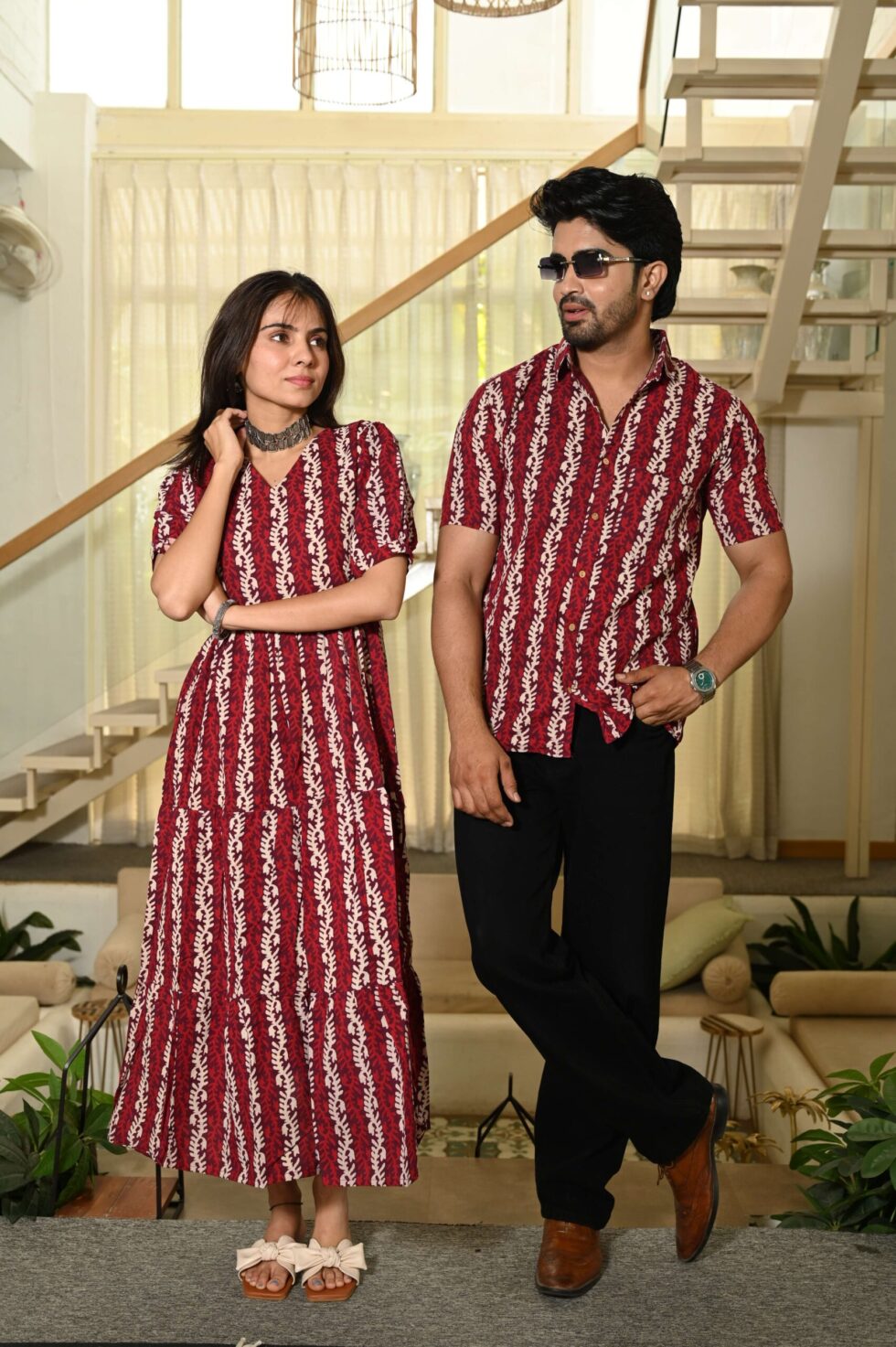 Detailed view of the intricate vertical vine handicraft pattern on red cotton fabric